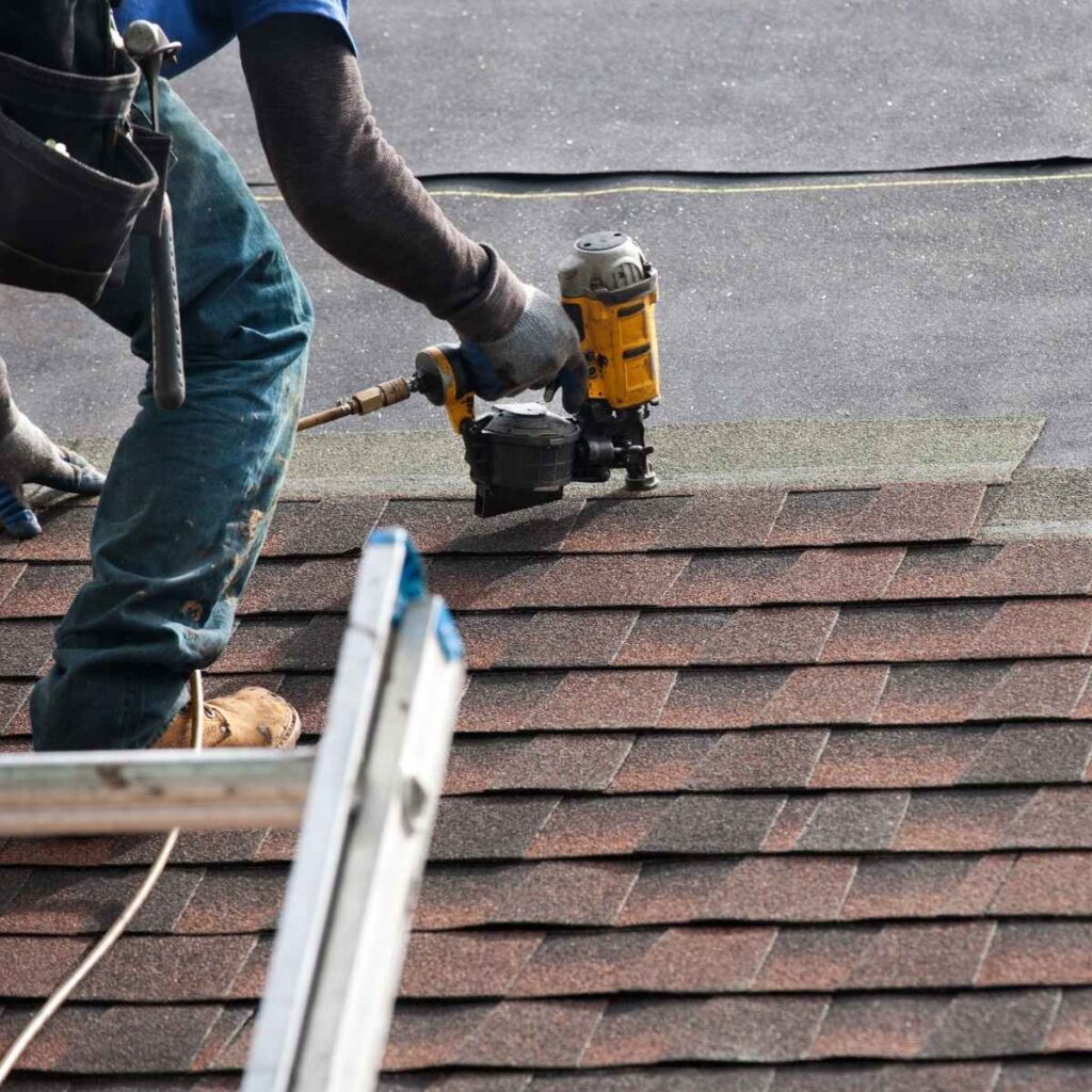 Roofing contractor installing a new roof